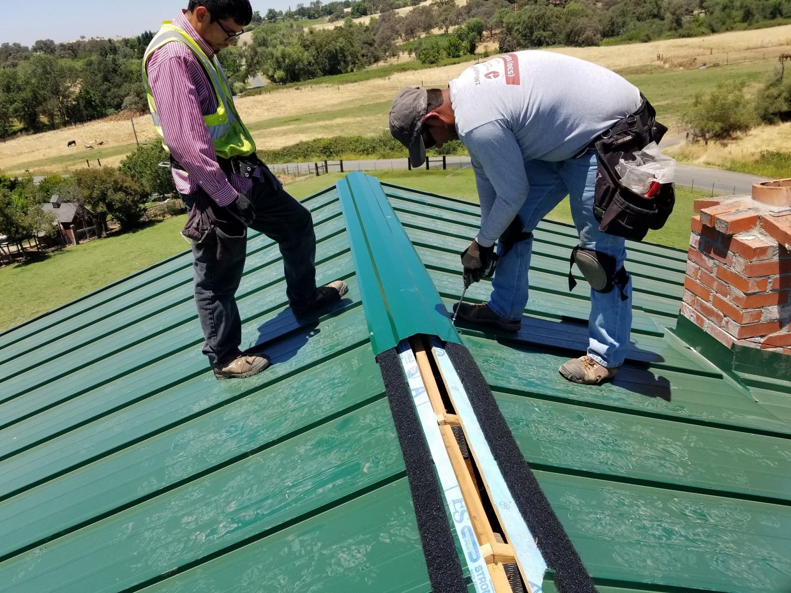 1NDONE Roofing Contractors working on a metal roofing project